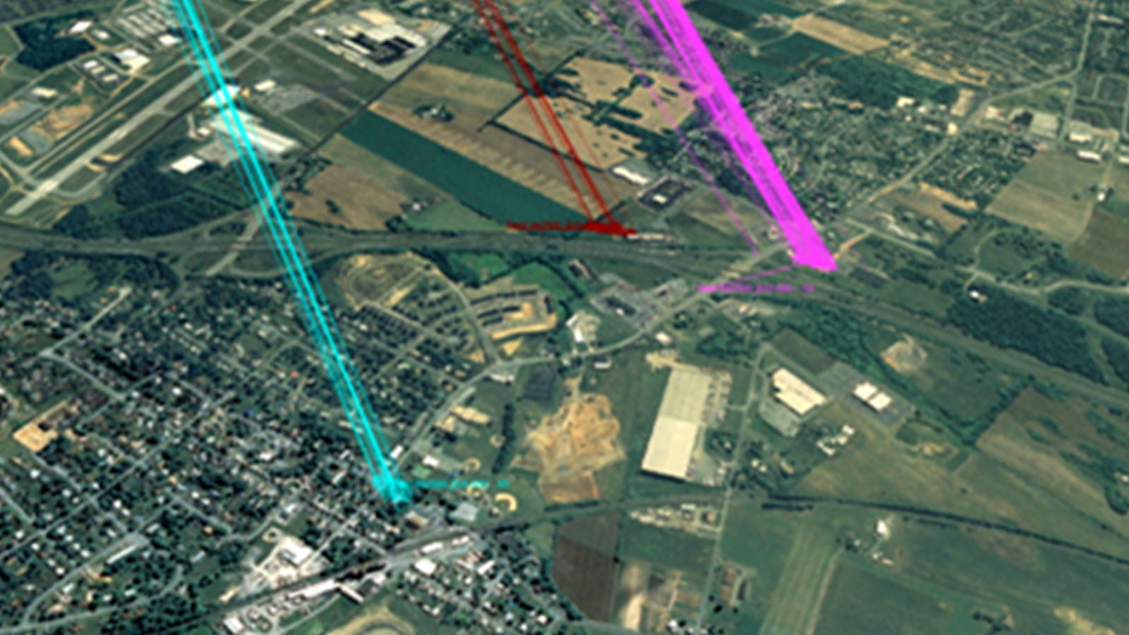 Aerial image of a city with cyan, red, and purple signals overlaid