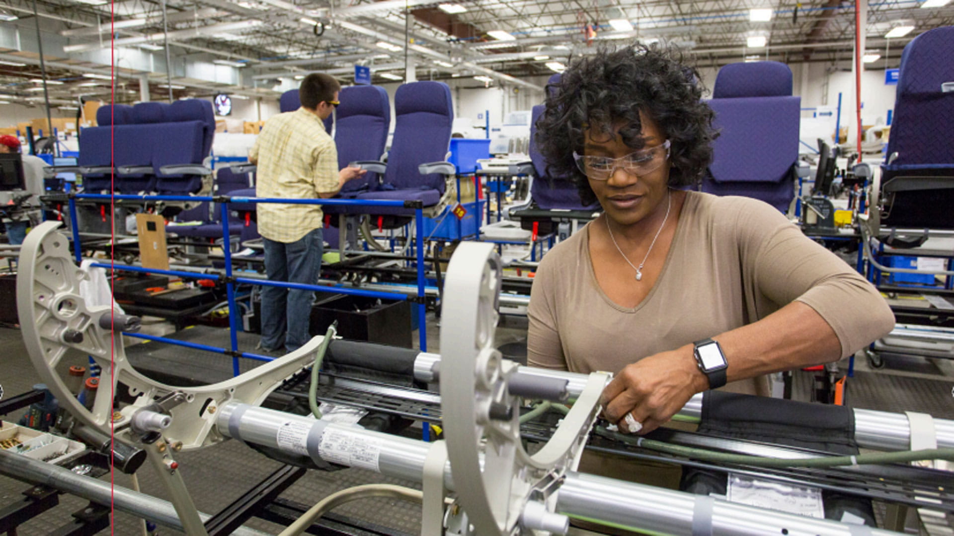 A woman works on an assembly line