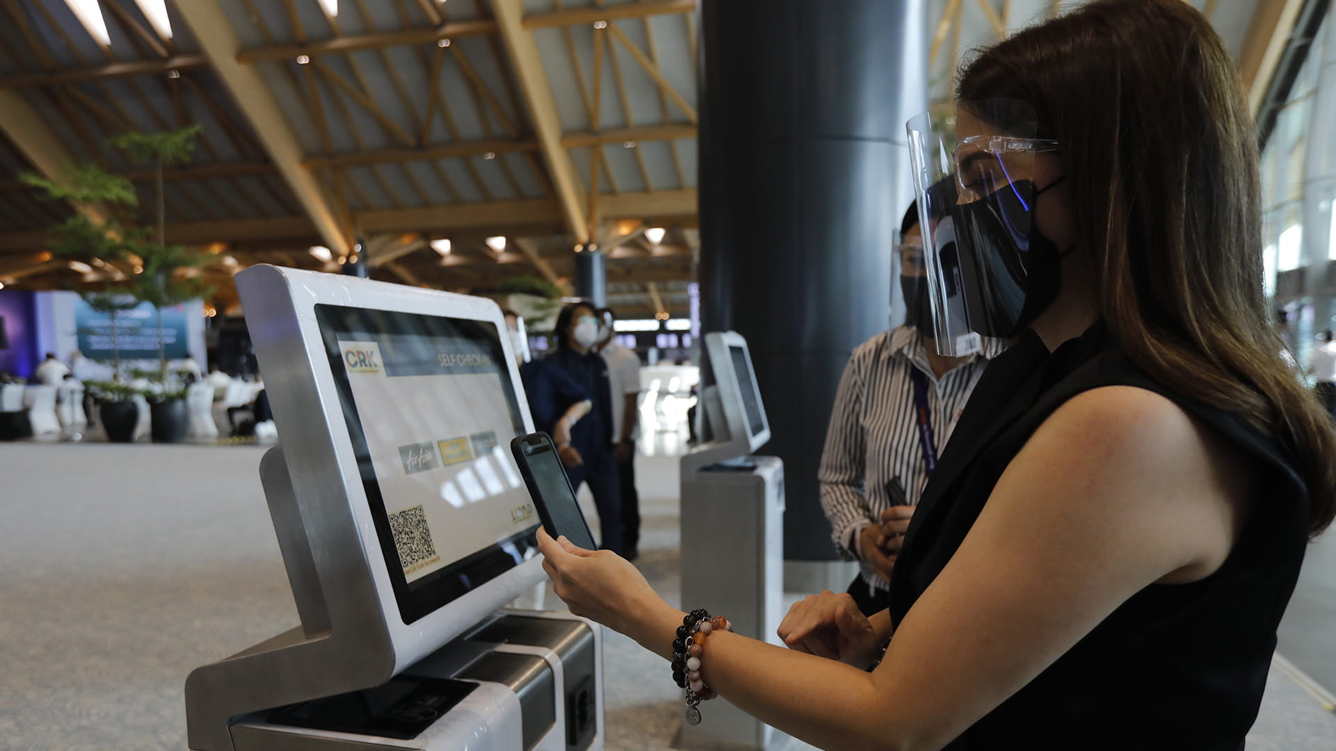 Woman using biometrics to check-in to flight