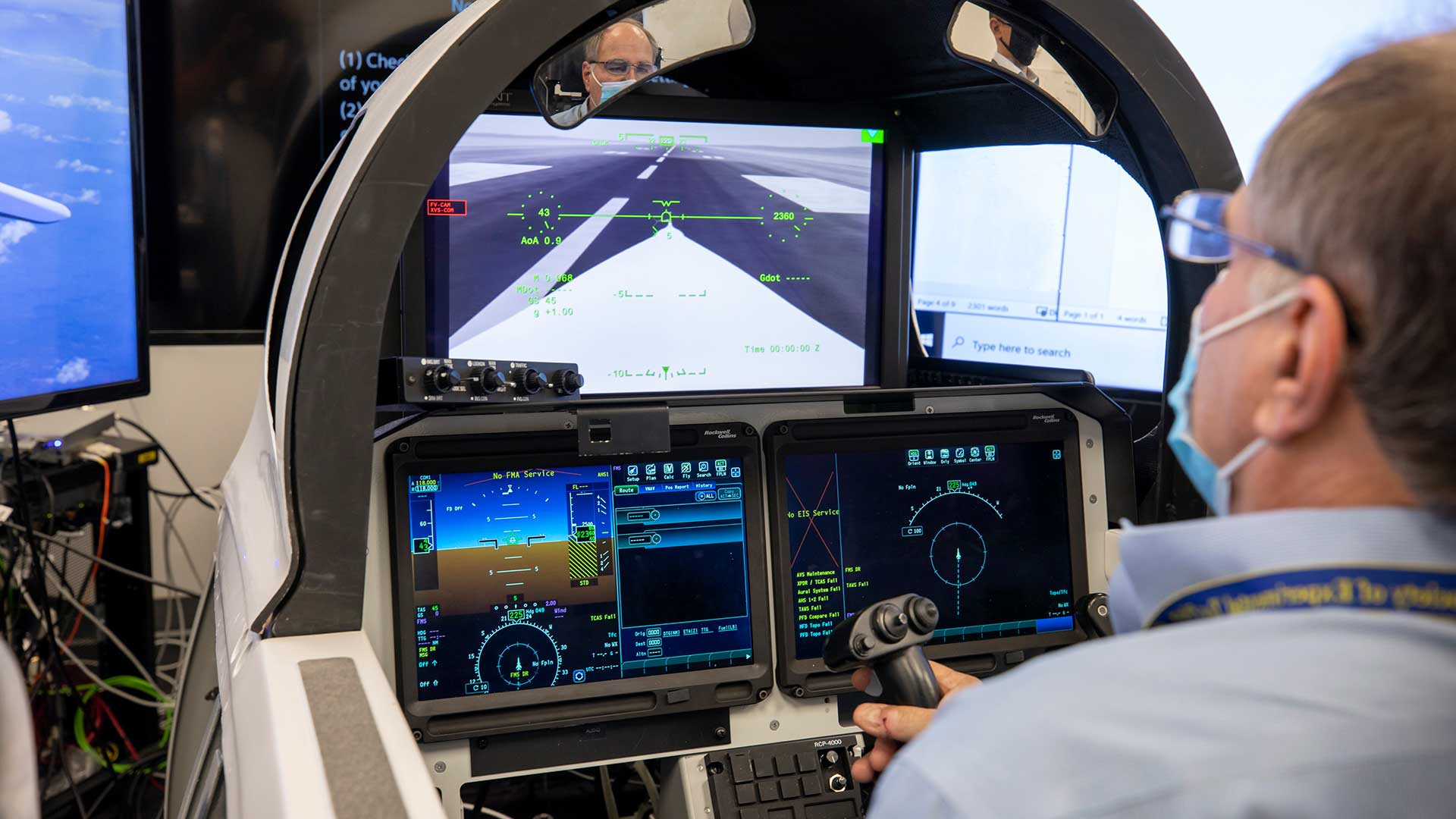man looking at flight displays on a simulator