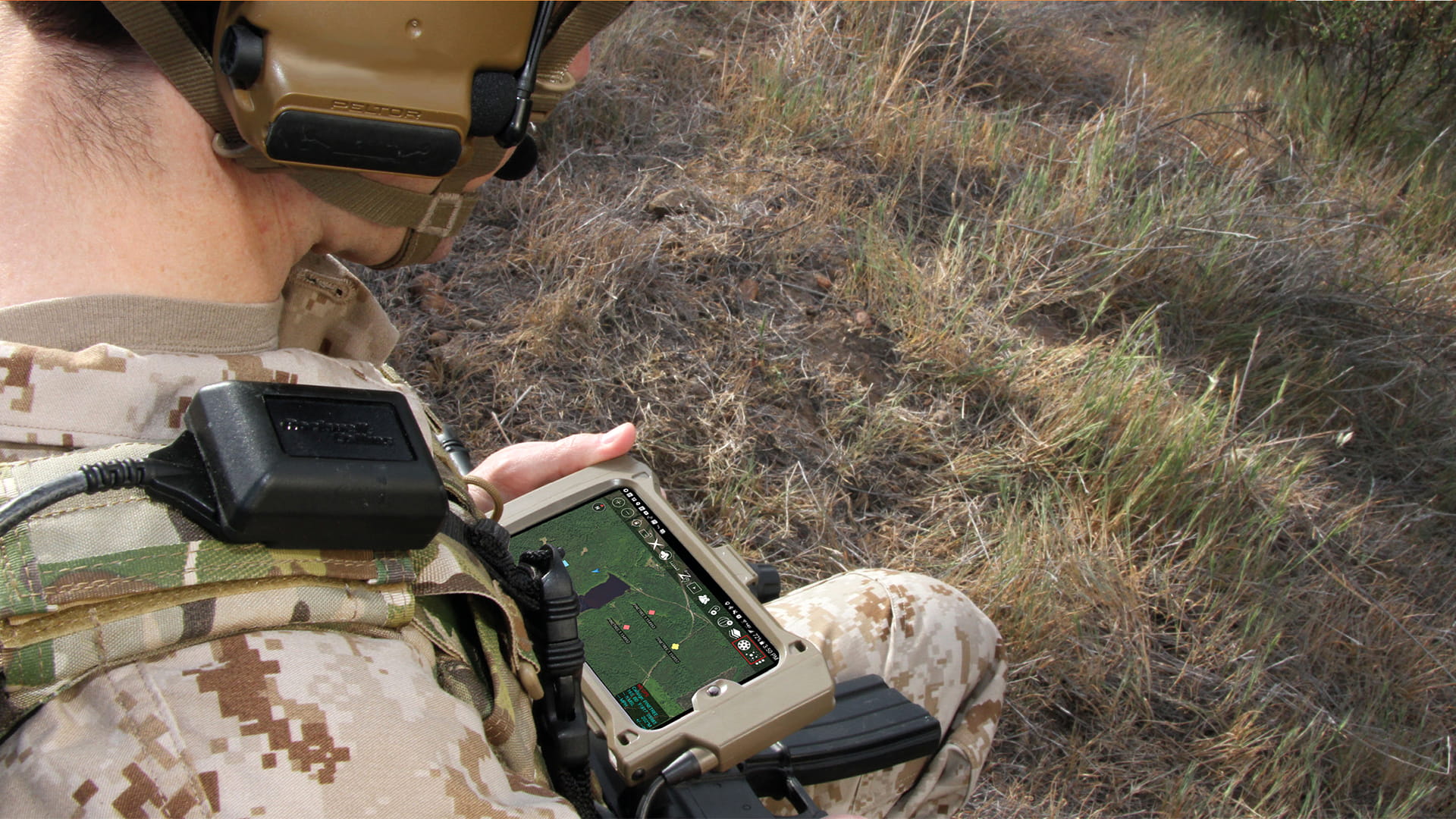Soldier looking at his FasTAK integrated targeting system