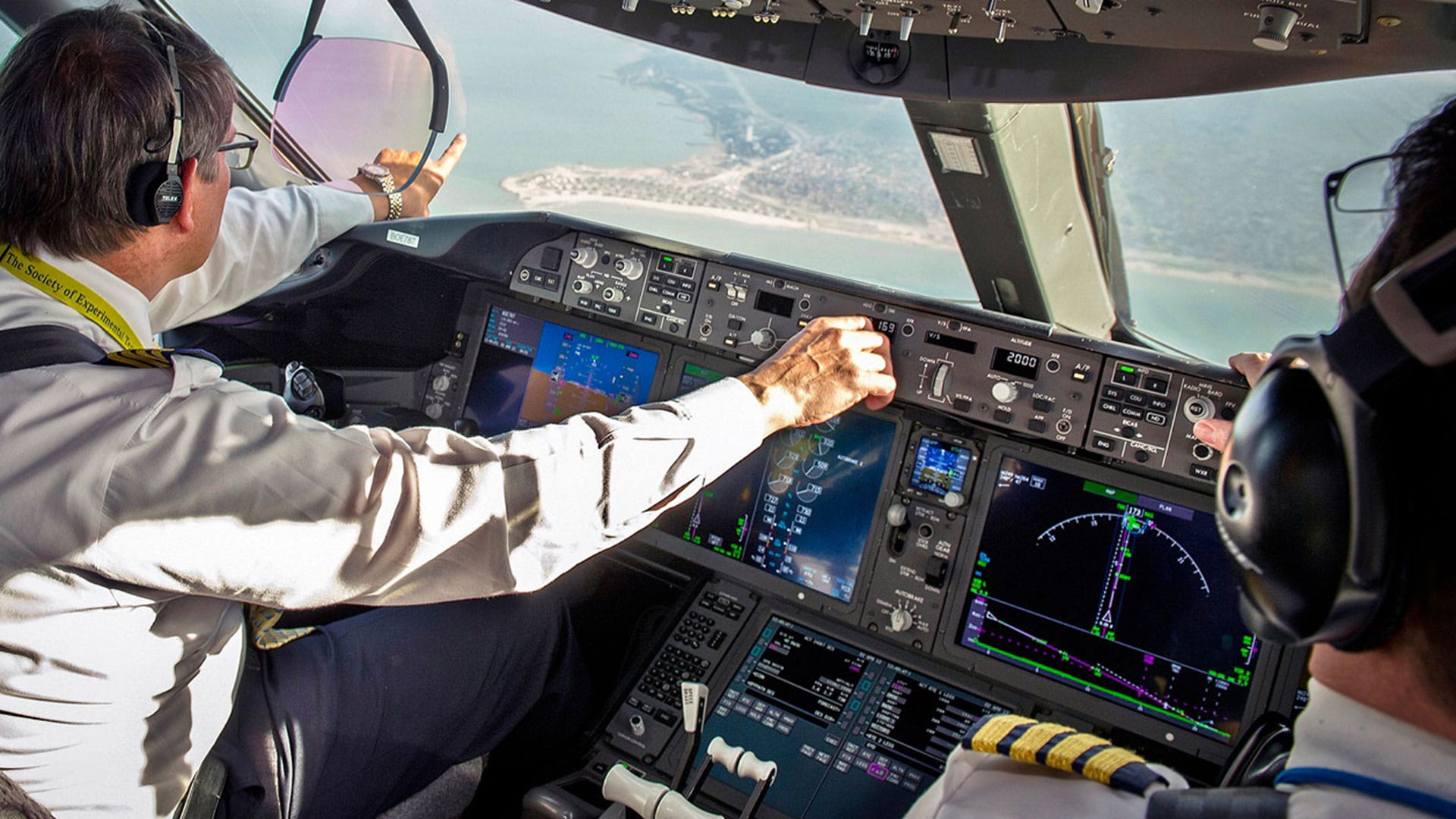 pilot pointing out to land from cockpit