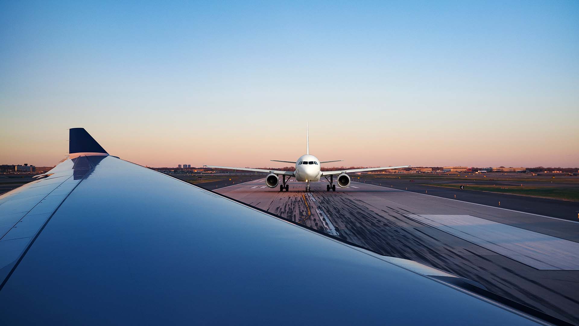 Airbus A320 at airport runway - wing view