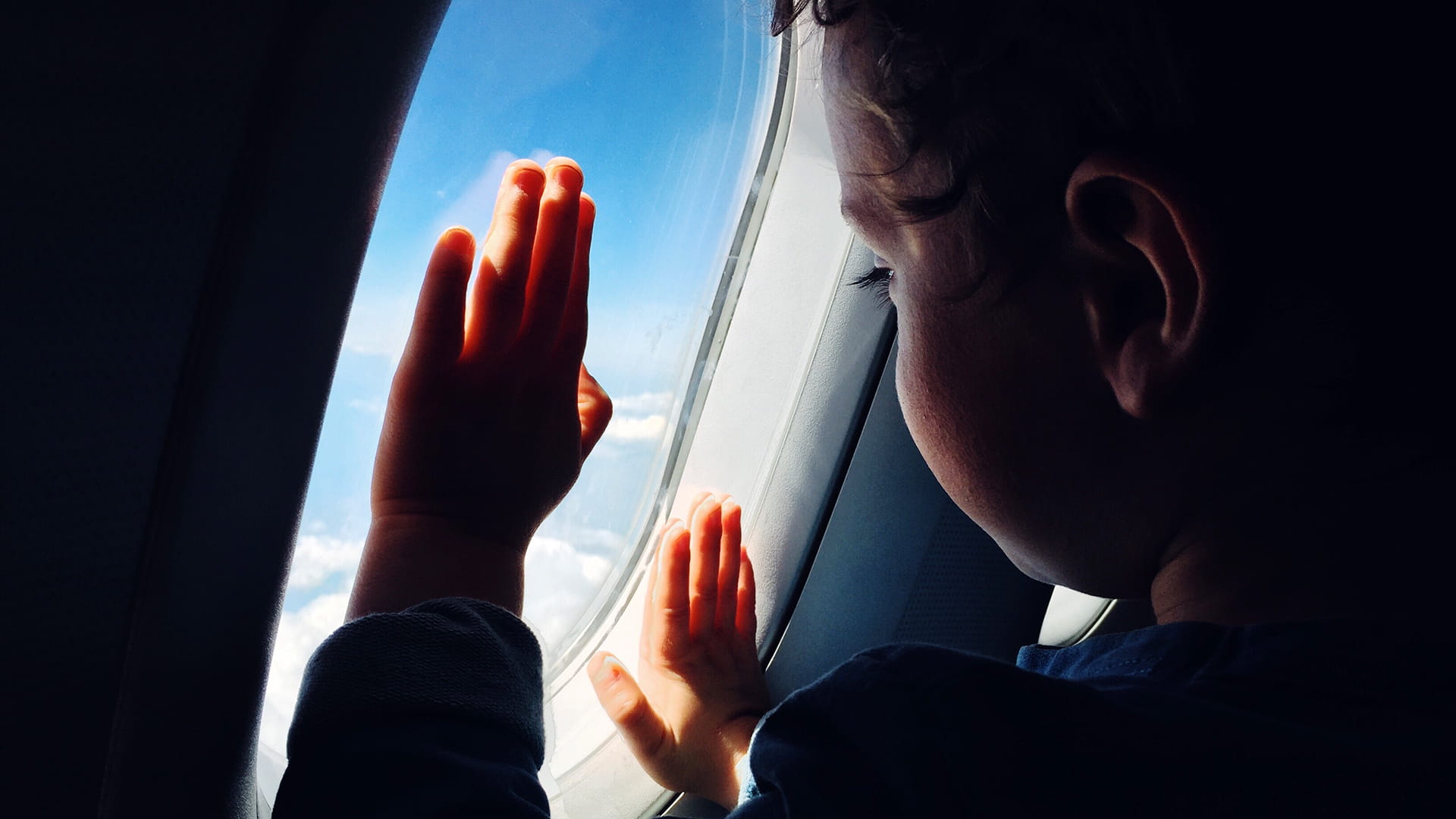 Boy looking out plane window