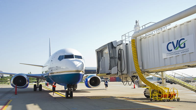 An airplane parked at an airport jet bridge