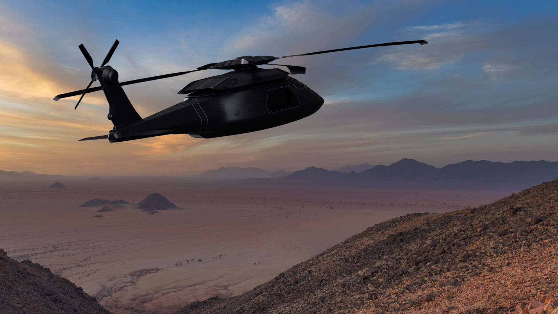 A concept Future Vertical Lift helicopter flies over a desert mountain
