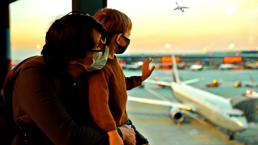Man and boy looking outside airport runway