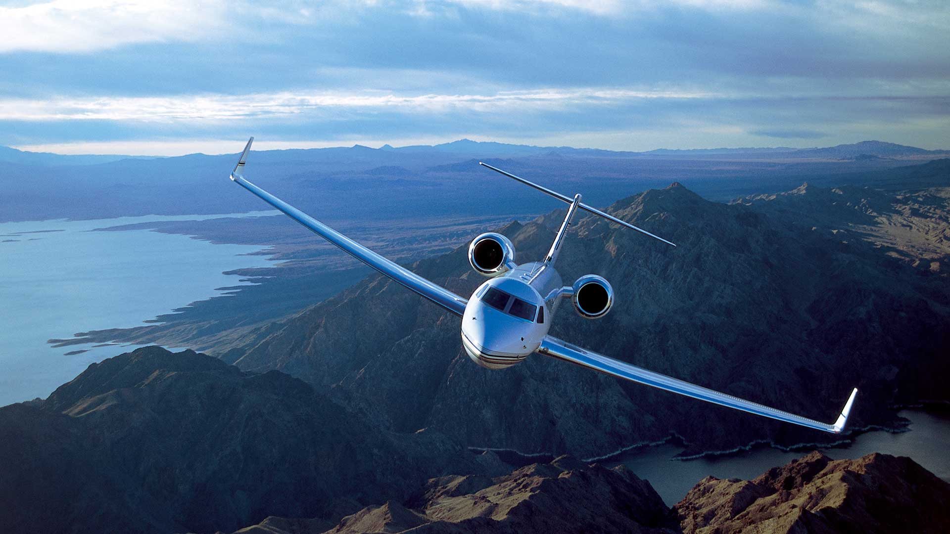 Gulfstream jet flying over mountains