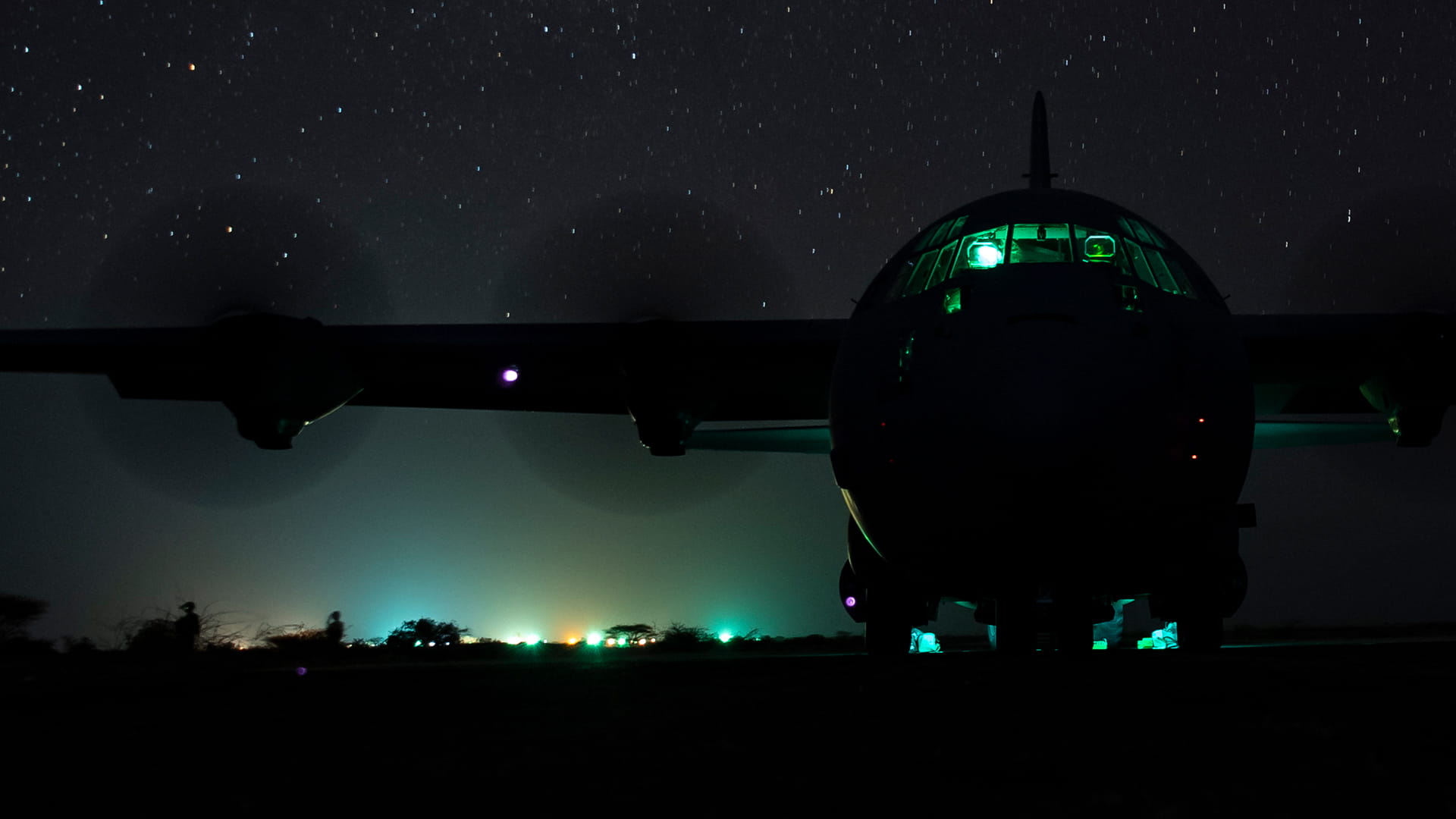 Military C130 flying in the night