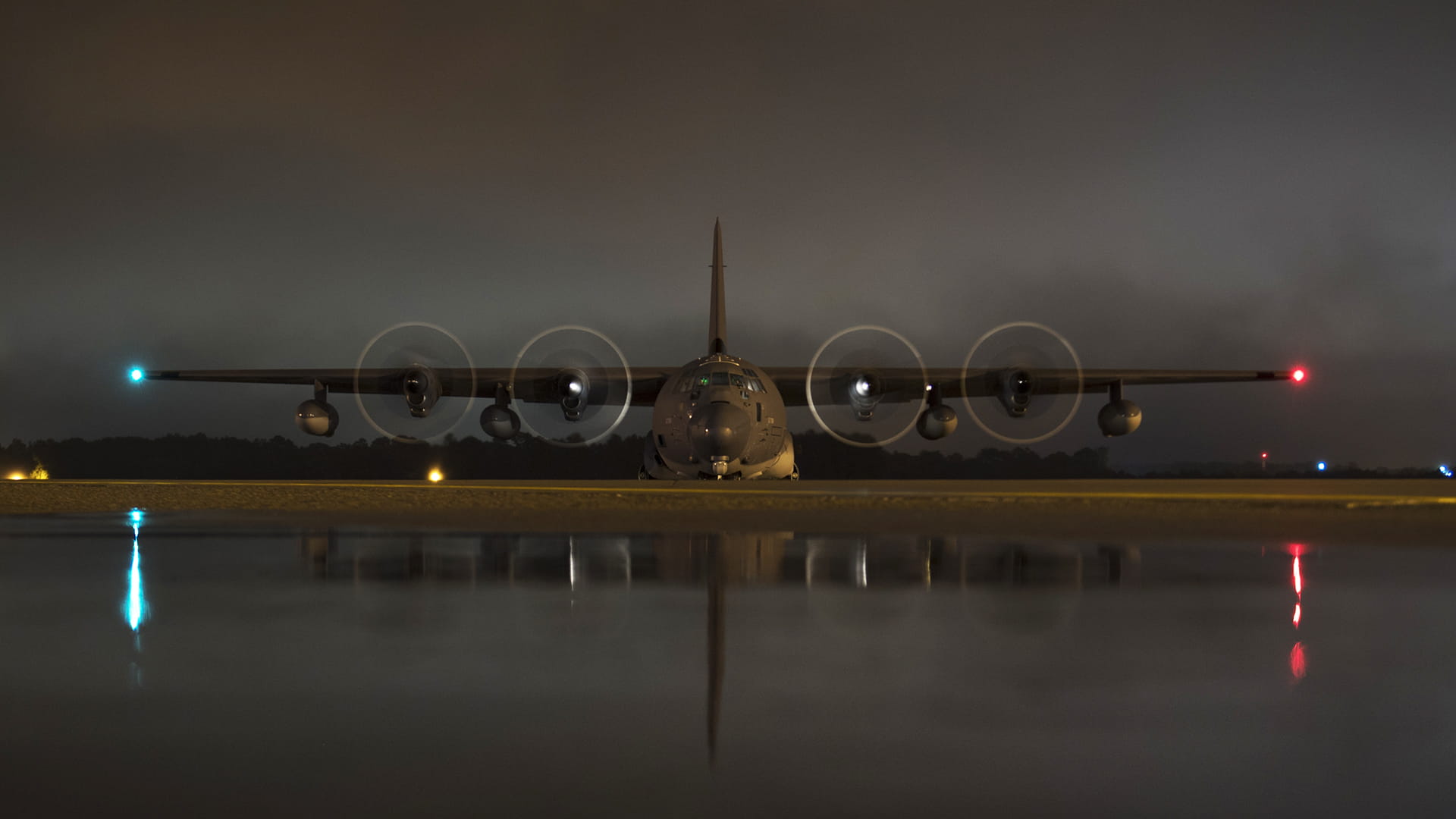 Military C-130 plane with propeller spinning