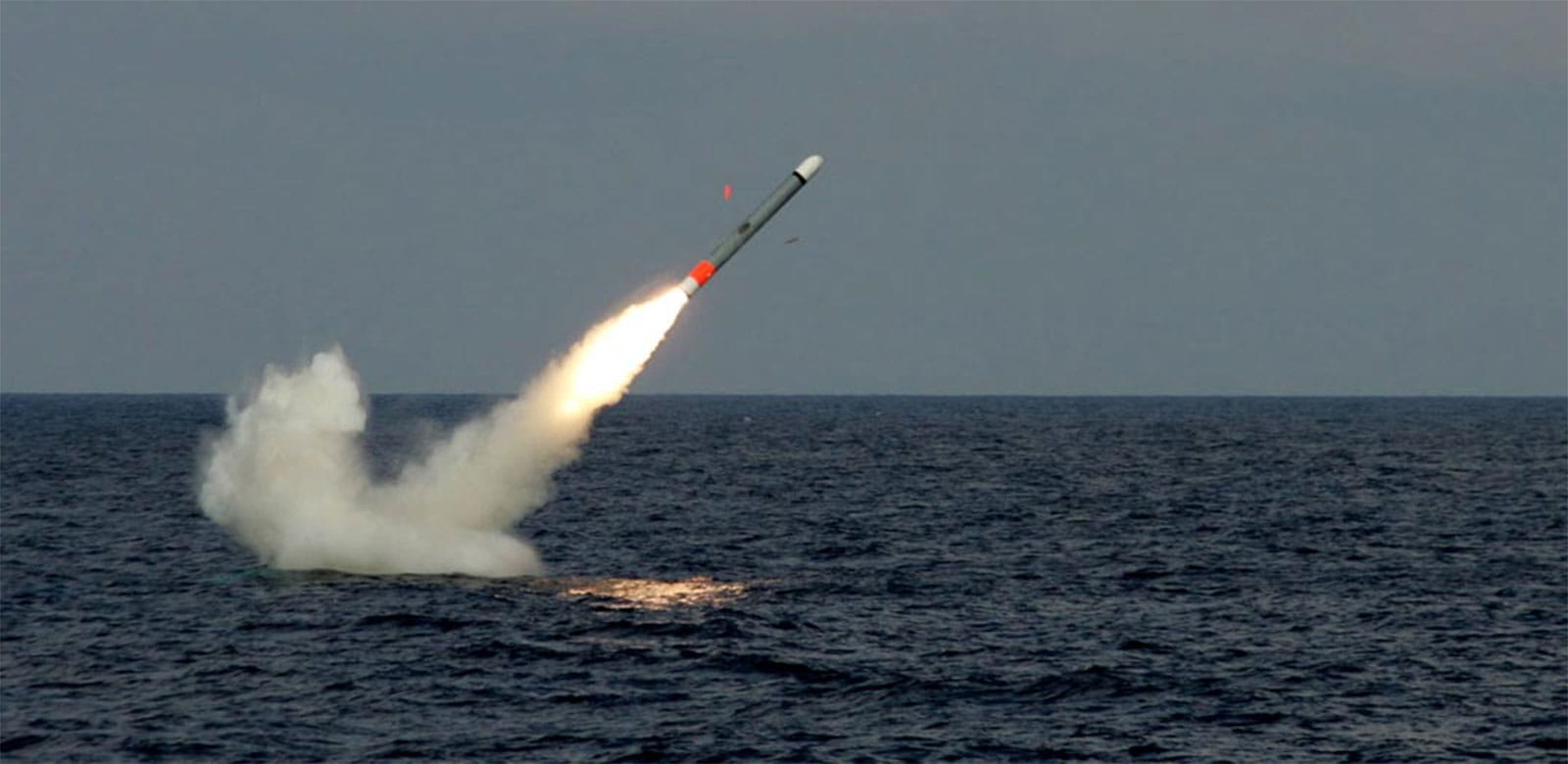 Tomahawk missile emerging from water after being launched from a submarine