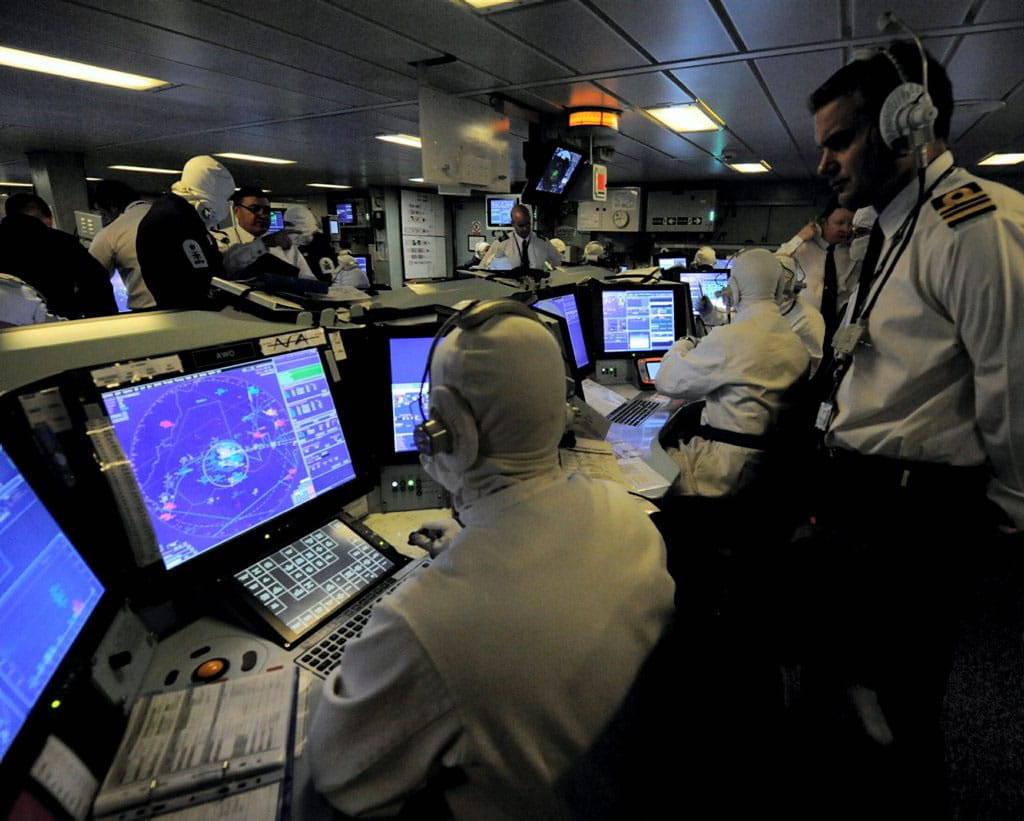 Members of the Warfare department are pictured sitting radar consoles in the Operations Room onboard HMS (Crown Copyright)