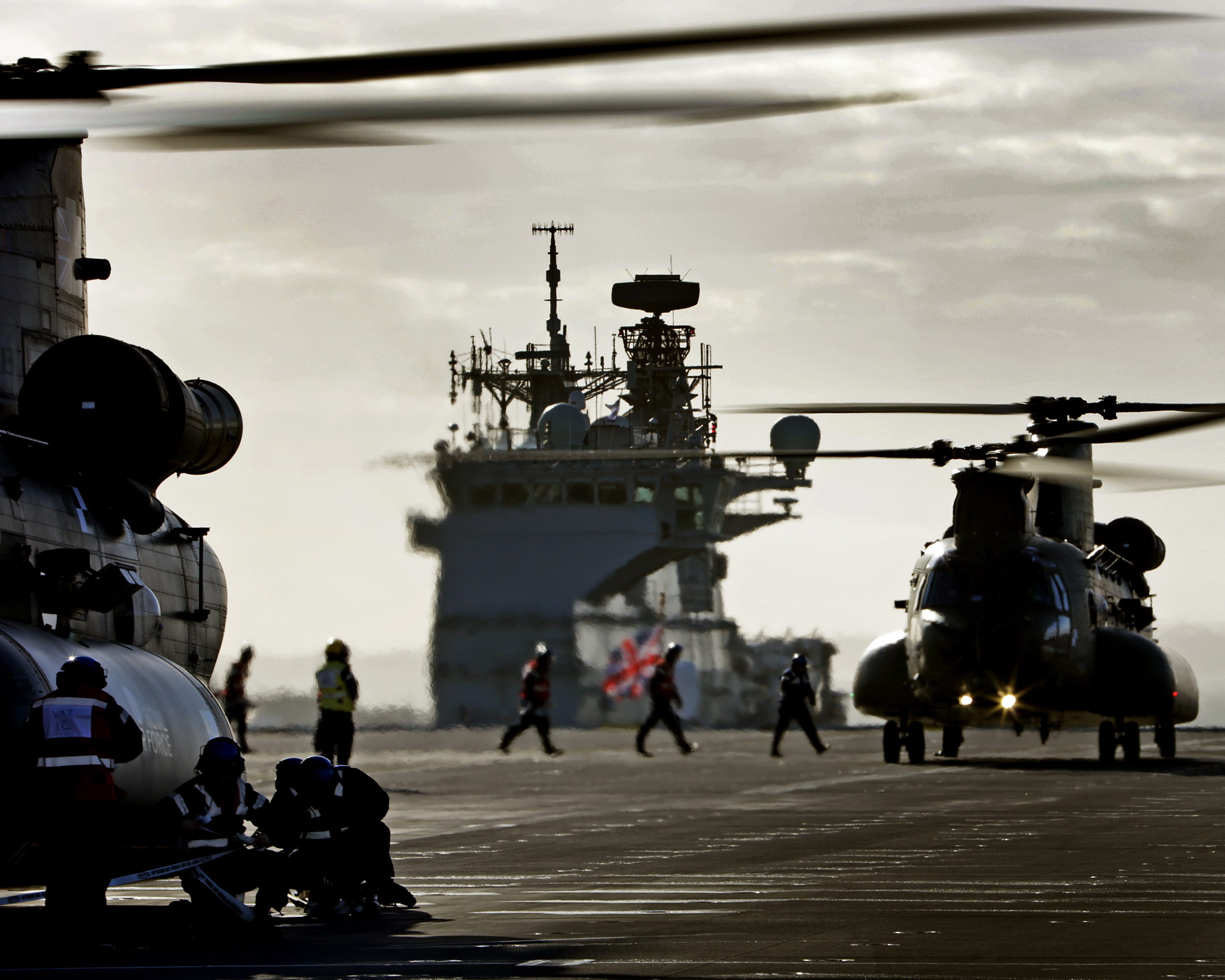 Pictured are two Royal Air Force Chinook helicopters landing on the Royal Navy’s HMS Queen Elizabeth aircraft carrier for the first time. (Crown Copyright)