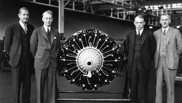 Members of Pratt & Whitney stand next to the wasp engine.