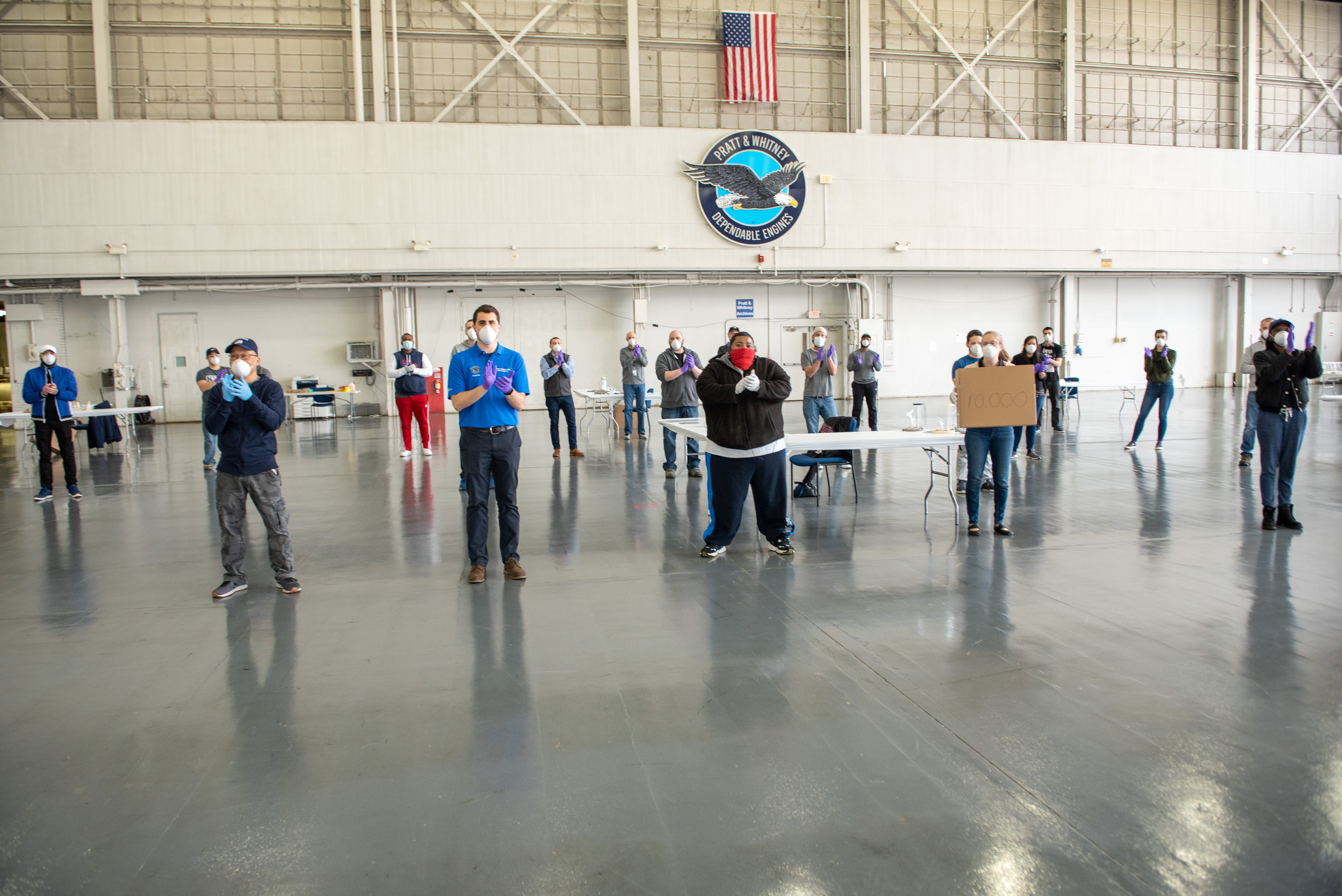 A team from Pratt & Whitney, one of four businesses that form Raytheon Technologies, prepares medical-grade face shields for shipment while practicing social distancing in response to the COVID-19 emergency.