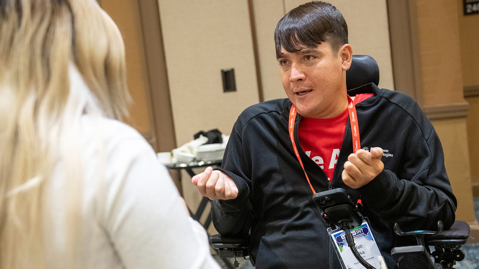 Matt Oka, the chair of Raytheon Technologies’ employee resource group for people with disabilities, speaks with a colleague at the company’s Employee Resource Group Leadership Summit. Employee resource groups are a key part of Raytheon Technologies’ strategy to strengthen its culture of inclusion.