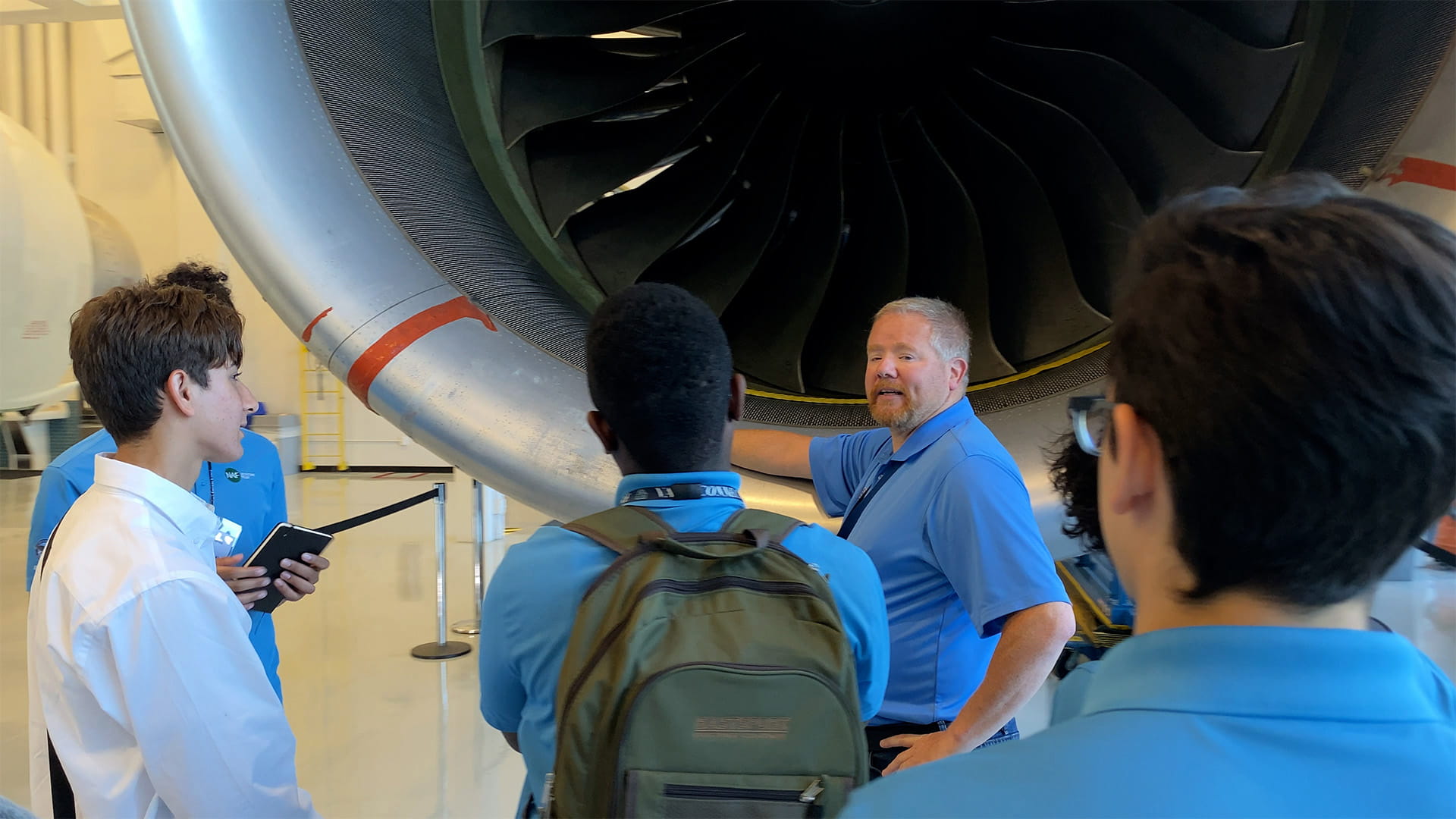 Students from NAF get an up-close look at a Pratt & Whitney engine as part of their internship