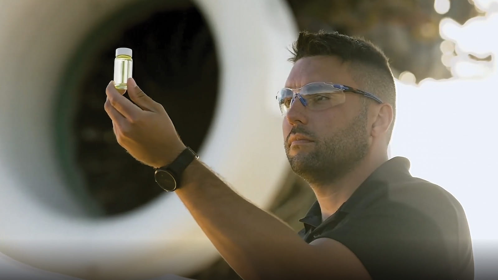 man inspects alternate aviation fuel source
