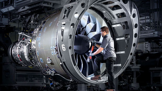 A man standing inside of a GTF engine.