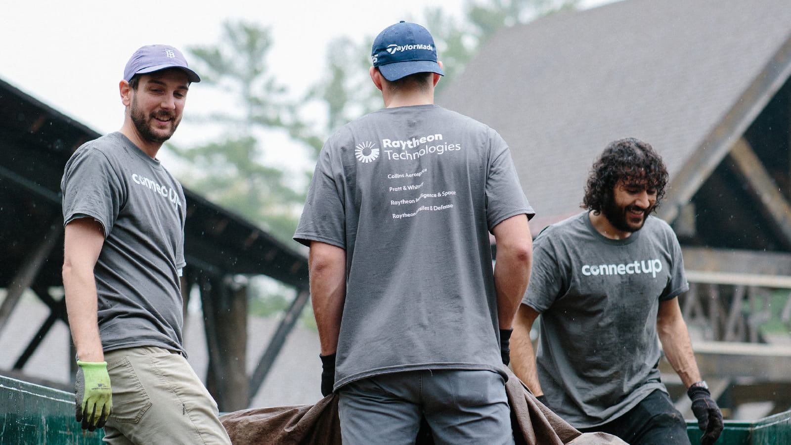 Three male employees volunteering while wearing ConnectUp shirts